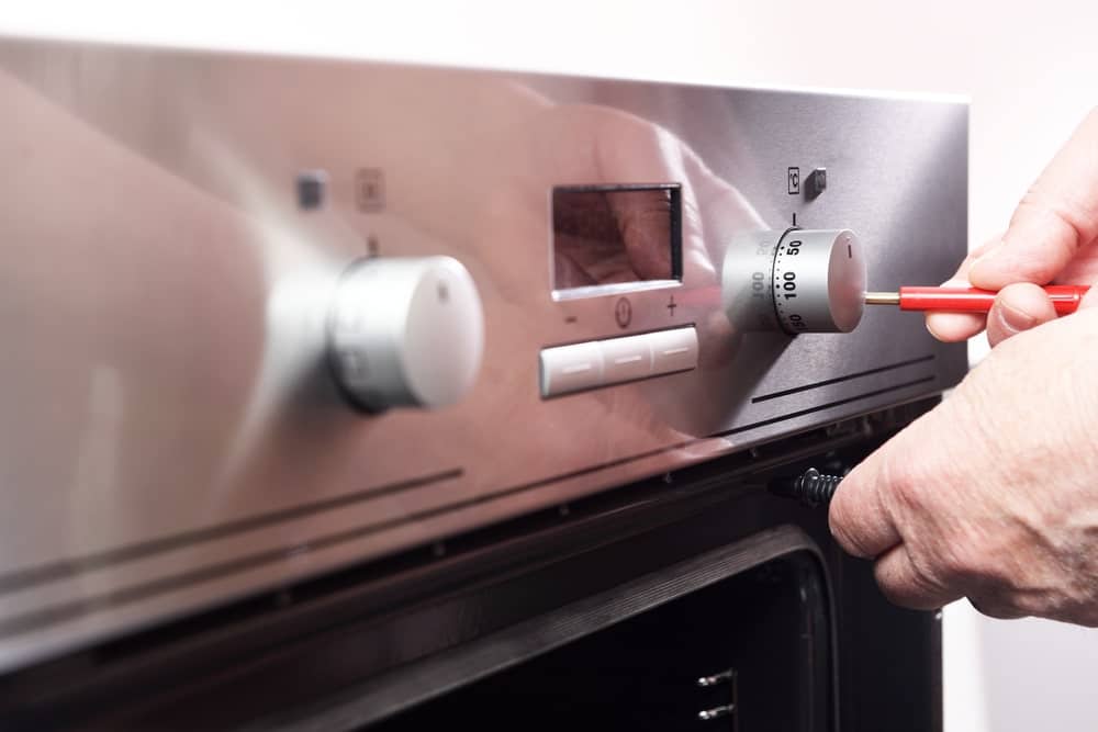 man fixing electric stove