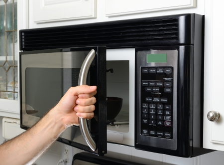man opening a microwave