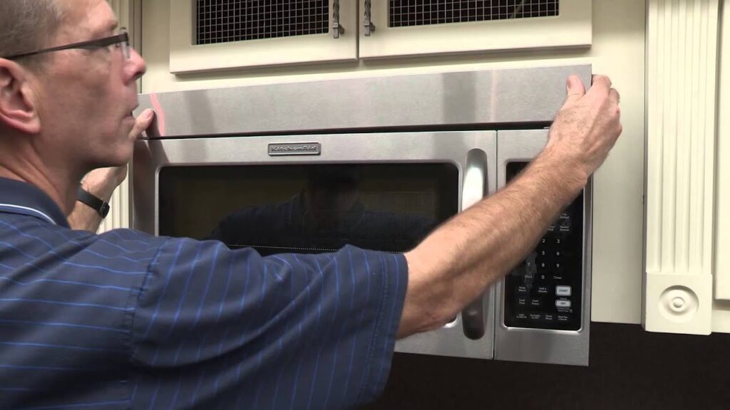 man in front of the microwave