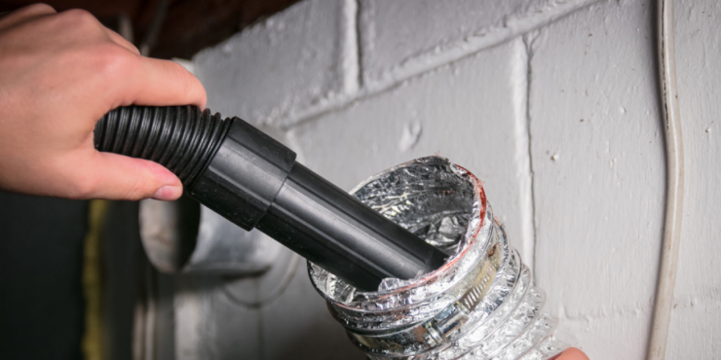 cleaning a dryer vent with a vacuum cleaner hose