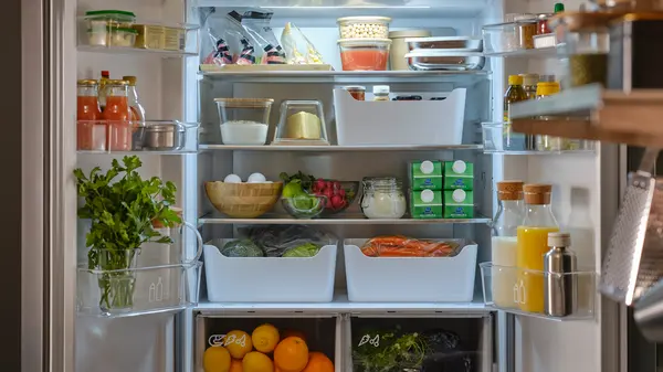 an organized refrigerator using IKEA's KLIPPKAKTUS storage boxes and other containers
