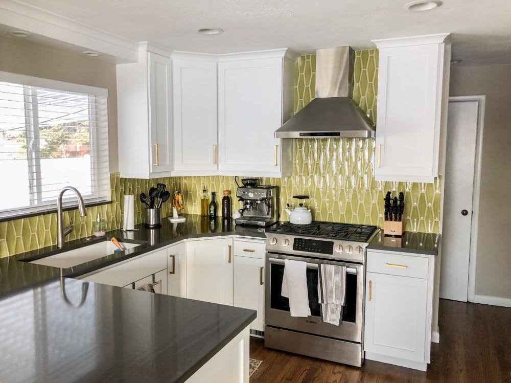 a kitchen with a stainless steel range hood over a stove