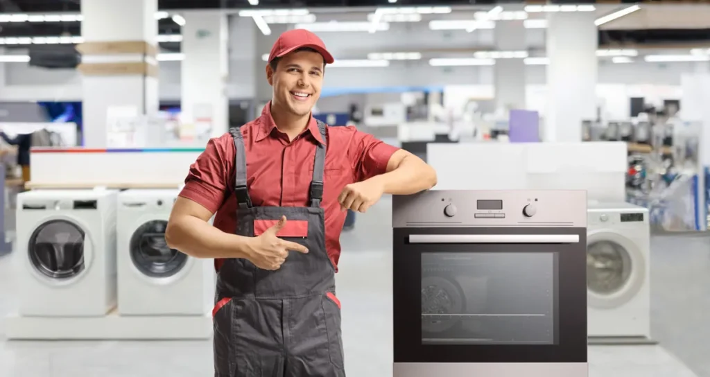 a salesman pointing at a Bosch built-in oven inside an appliance shop