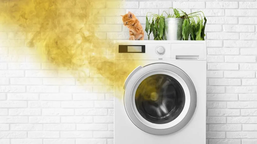 depicts a front-load washing machine in a laundry area, with a yellow, smoke-like effect digitally added to the left side of the image