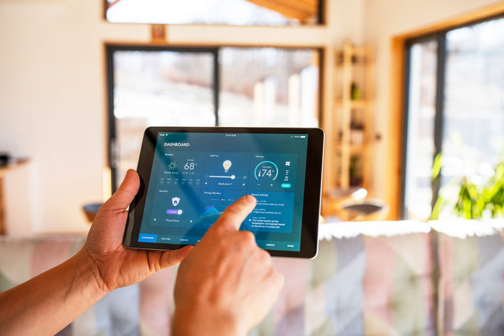 a person using a tablet to control a smart home system