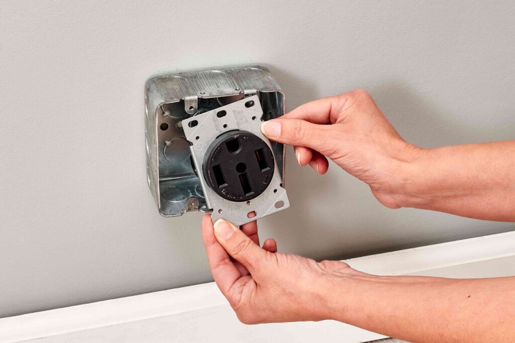 a 50-amp 125/250-volt round range power outlet being installed in a wall box