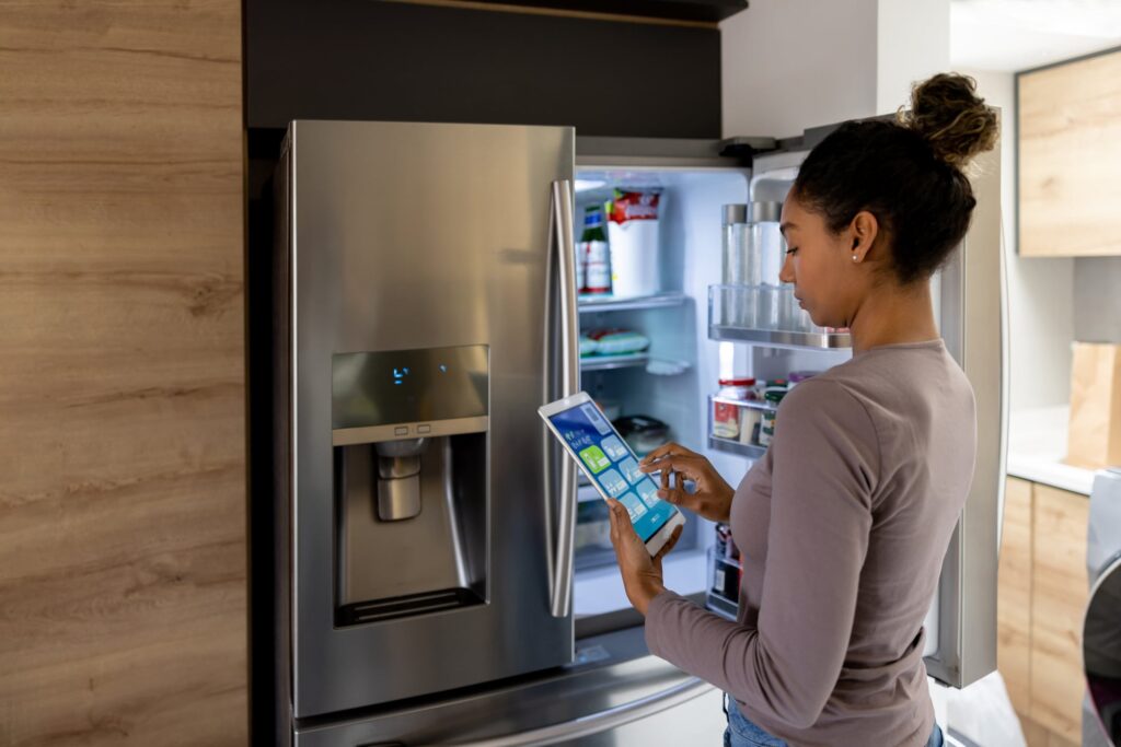 Interacting with a smart refrigerator, which is an appliance with internet connectivity and advanced features.