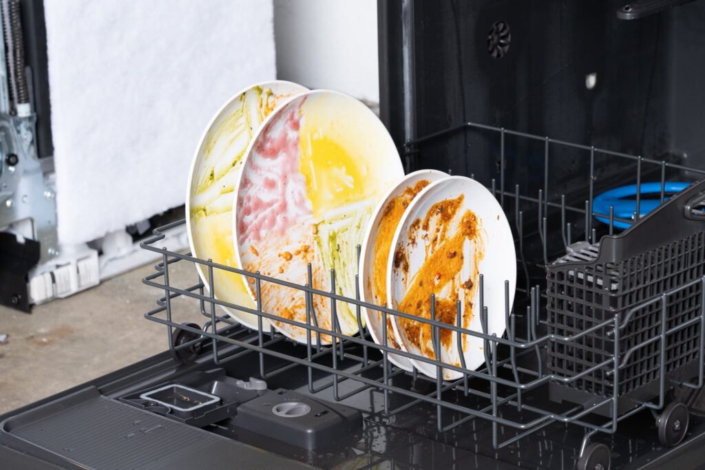 dirty dishes loaded into a dishwasher