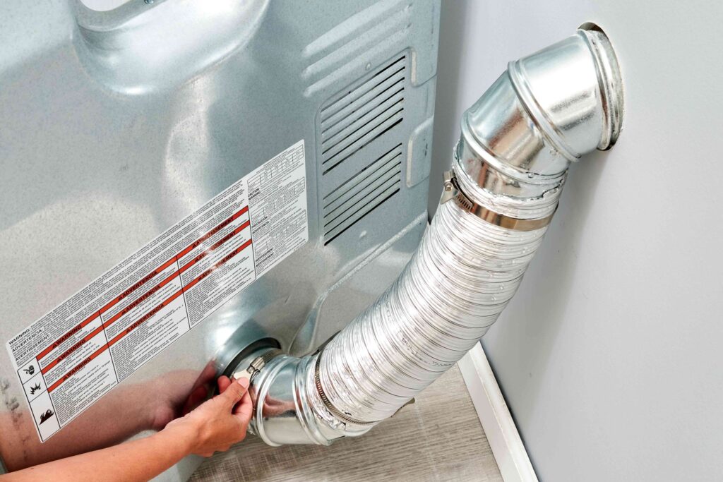 a person connecting a semi-rigid metal dryer vent duct