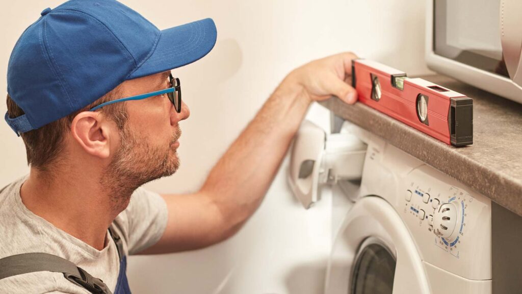 technician balancing a washing machine