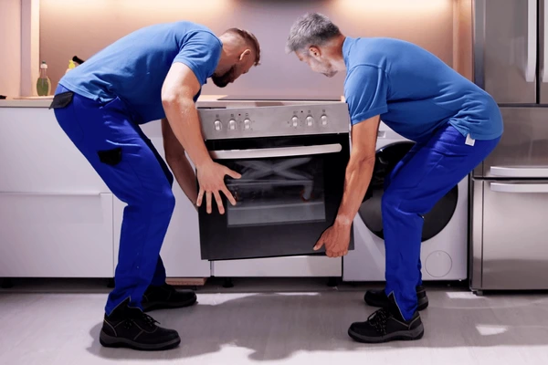 two man installing the oven