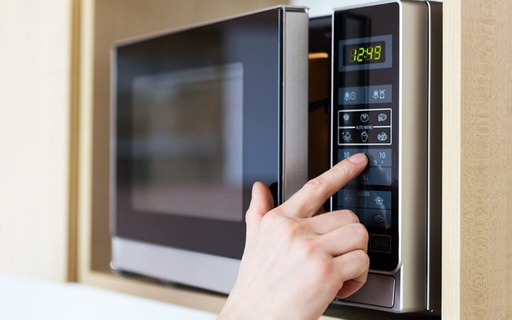 a person using a microwave oven