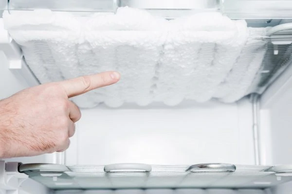 A buildup of ice inside a freezer compartment.