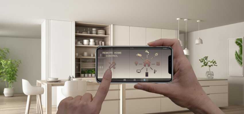  person using a smartphone app for a remote home control system in a modern kitchen setting