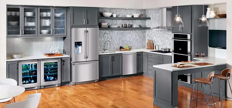 a modern kitchen with gray shaker cabinets and stainless steel appliances